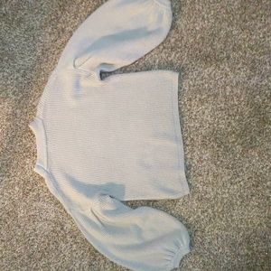 grey cropped sweater with wide sleeves.